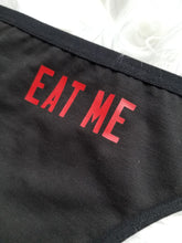 Load image into Gallery viewer, close up of eat me design red text on black thong
