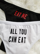 Load image into Gallery viewer, Eat me design red text on black thong, All you can eat design black text on white thong