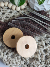 Load image into Gallery viewer, two bamboo lids with straw holes shown with glass and metal straw options.