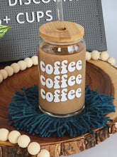 Load image into Gallery viewer, Coffee Coffee Coffee white decal on glass beer can. Shown with optional bamboo lid and glass straw.