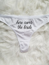 Load image into Gallery viewer, Women&#39;s white thong with &quot;Here cums the bride&quot; in black cursive text.
