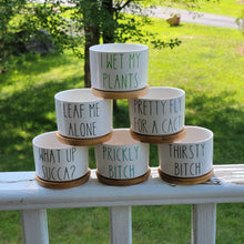 Load image into Gallery viewer, Stack of small white ceramic succulent pots with funny sayings on them in different colored vinyl. Sayings include &quot;I Wet My Plants&quot;, &quot;Leaf Me Alone&quot;, &quot;Pretty Fly For A Cacti&quot;, &quot;What Up Succa?&quot;, &quot;Prickly Bitch&quot;, and &quot;Thirsty Bitch&quot;.
