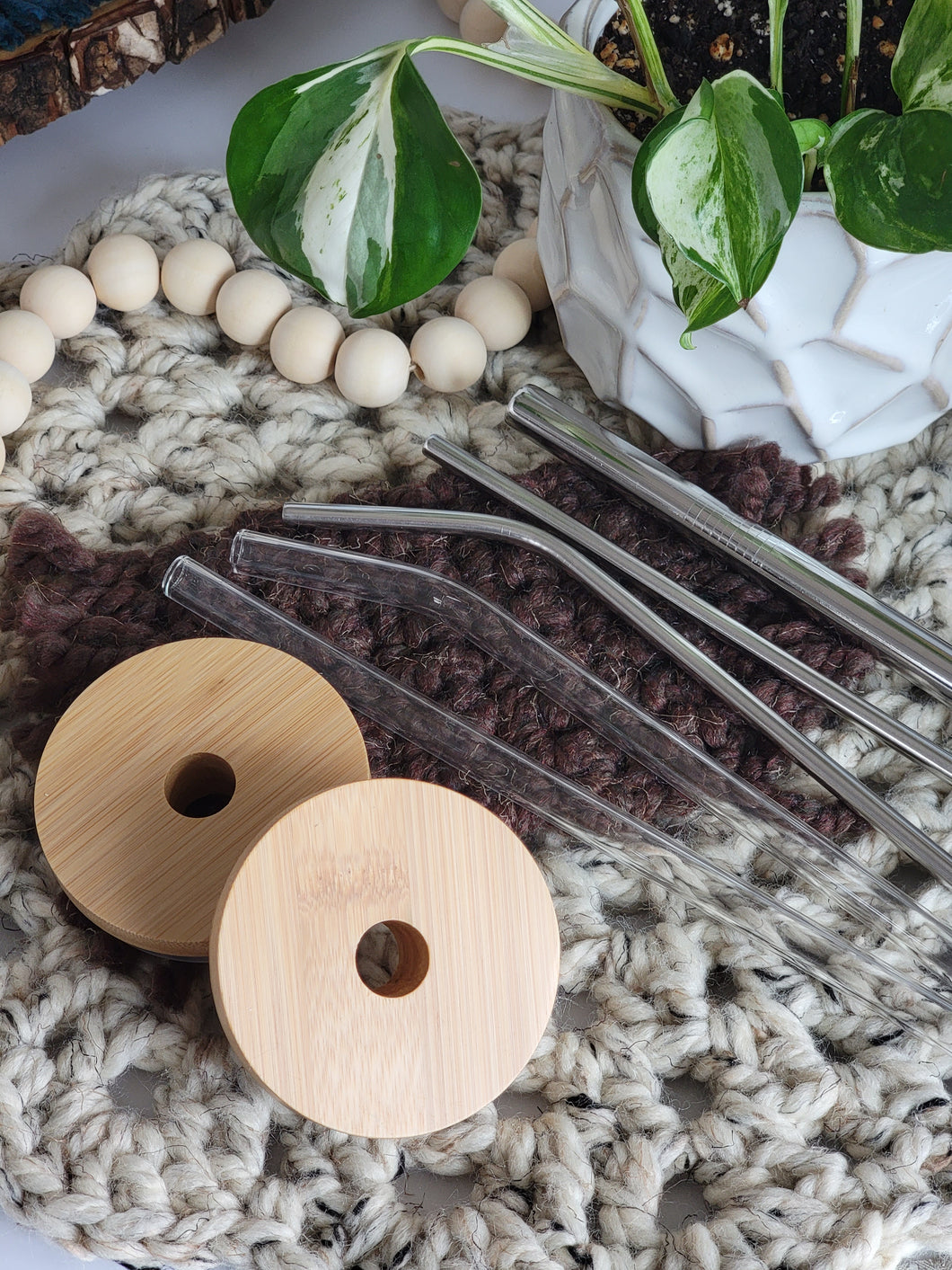 Two bamboo lids shown with glass straw options. Glass straight or bent straw. Metal straight or bent straw, or metal boba/bubble tea straw.