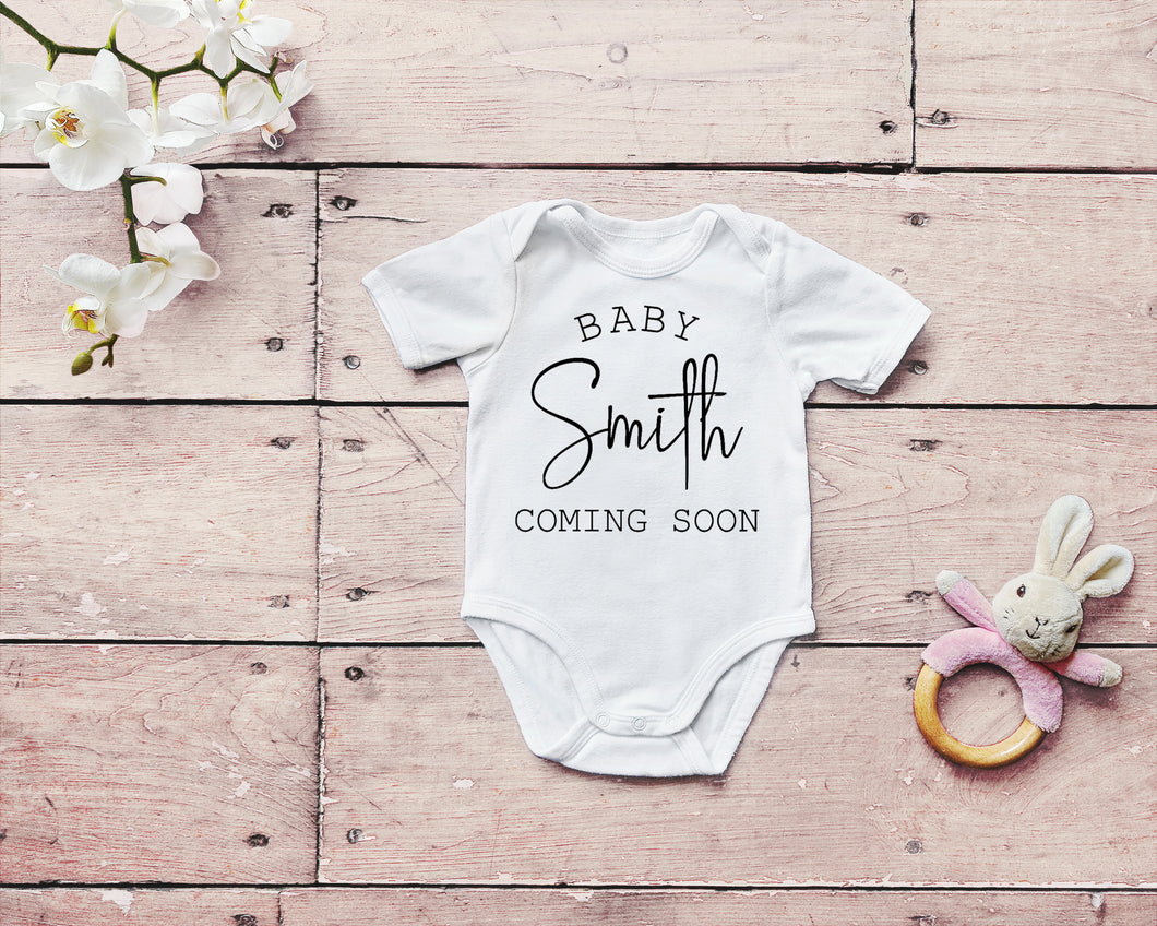 White baby bodysuit with text 