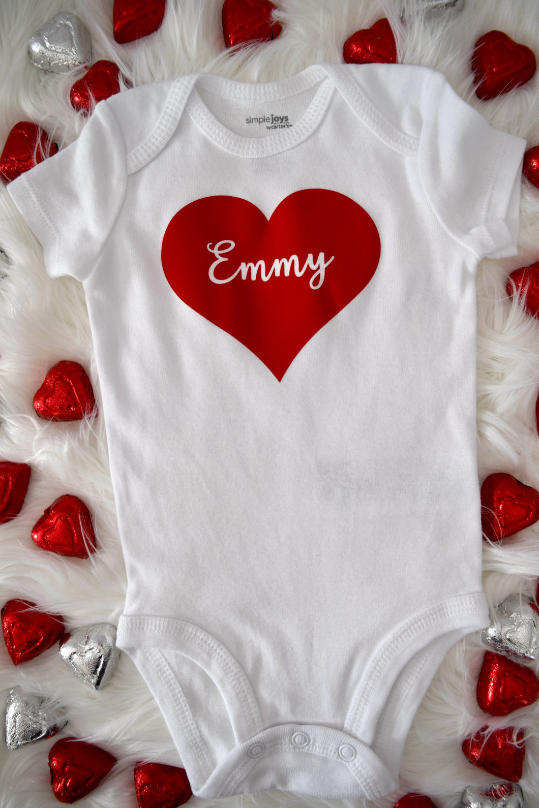 Valentine's Day Baby Bodysuit. White bodysuit with solid red heart with child's name in the middle