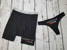 Load image into Gallery viewer, Men&#39;s Black boxer briefs and a black thong. The design on the men&#39;s boxer briefs says Property of Jennifer with red kiss lips next to the name. The women&#39;s thong says property of Shane with a red heart next to the name.

