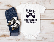 Load image into Gallery viewer, White baby bodysuit with picture of gaming controller. Text says &quot;player 3 has entered the game&quot;.

